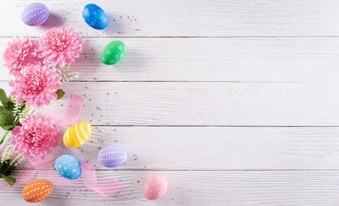 Happy easter! Colourful of Easter eggs in with flower on white wooden backgro Stock Photos