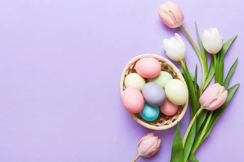 Happy Easter composition. Easter eggs in basket on colored table with yello.. 스톡 사진