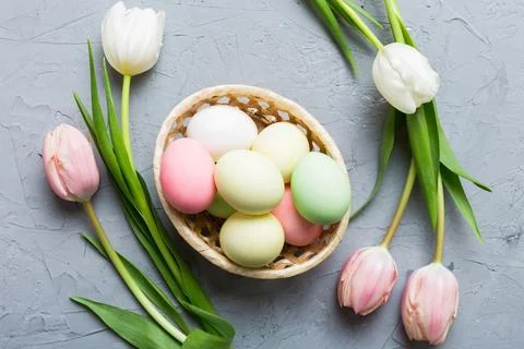 Happy Easter composition. Easter eggs in basket on colored table with yellow  写真素材