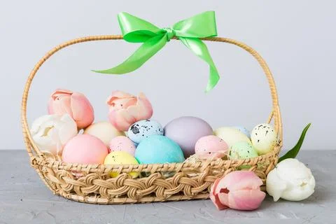Happy Easter composition. Easter eggs in basket on colored table with yellow  Foto stock