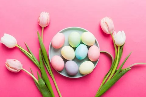 Happy Easter composition. Easter eggs in basket on colored table with yello.. Stock Photos