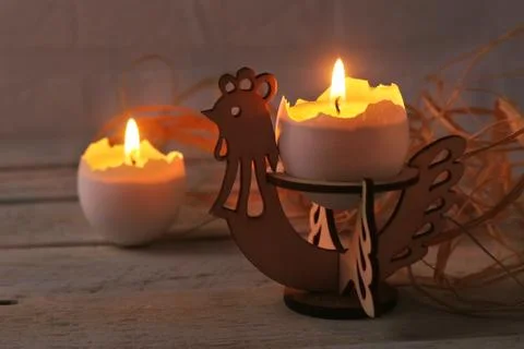 Happy easter composition with eggs and candles on Rustic background. Selective Stock Photos