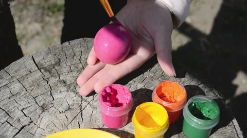 Happy easter concept. Close-up kid arms holding chicken's egg and color it to Stock Footage 172531057