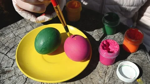 Happy easter concept. Close-up kid arms coloring chicken eggs with yellow color Stock Footage 172531642