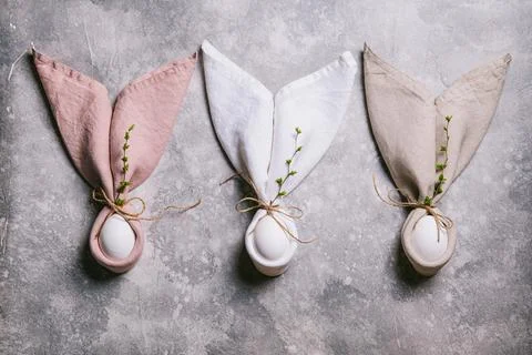 Happy easter concept. Easter bunny. Easter eggs and branches with buds on a g Stock Photos