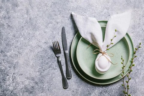 Happy easter concept. Easter bunny. Easter egg in a plate and branches with b Stock Photos