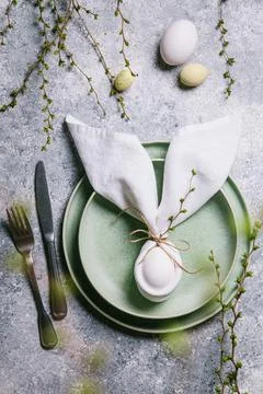 Happy easter concept. Easter bunny. Easter egg in a plate and branches with b Stock Photos