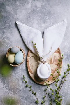 Happy easter concept. Easter bunny. Easter egg in a plate and branches with b Stock Photos