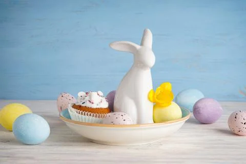 Happy Easter concept. Easter bunny and eggs with flower on a wooden backgroun Stock Photos