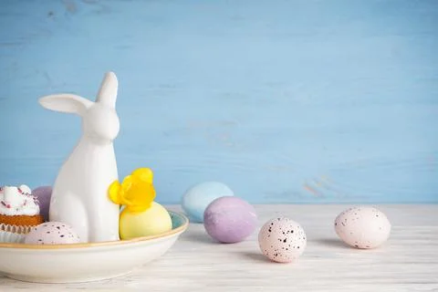 Happy Easter concept. Easter bunny and eggs with flower on a wooden backgroun Stock Photos