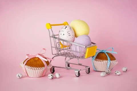 Happy Easter concept. Easter cake and Easter eggs in a cart with flowers on a Stock Photos