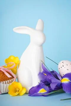 Happy Easter concept. Easter cake, Easter bunny and eggs with flowers on a bl Stock Photos