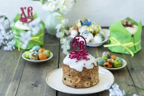 Happy easter concept. Easter wooden table with Easter cakes and colored eggs. Stock Photos