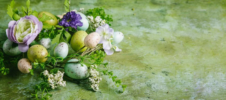 Happy easter concept. Easter wreath with multicolored easter painted eggs, fl Stock Photos