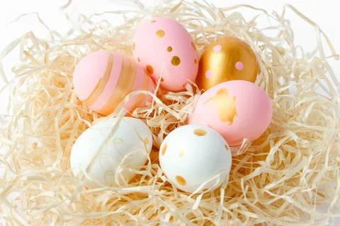 Happy Easter concept. Fancy Easter pastel colored eggs in nest. Stock Photos
