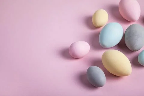 Happy easter concept. Multicolored easter painted eggs on a pastel pink backg Stock Photos