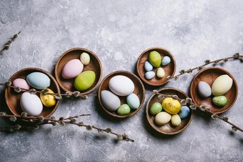 Happy easter concept. Multicolored easter painted eggs and branches with buds Stock Photos