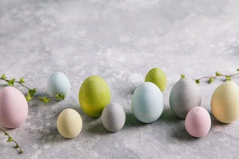 Happy easter concept. Multicolored easter painted eggs and branches with buds Stock Photos