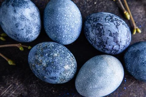 Happy easter concept. Multicolored easter painted eggs in blue tones and bran Stock Photos