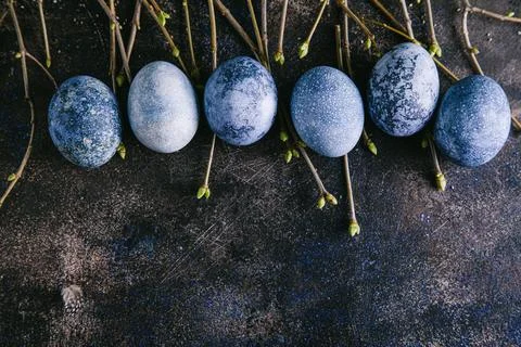 Happy easter concept. Multicolored easter painted eggs in blue tones and bran Stock Photos