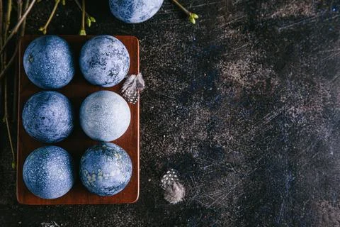 Happy easter concept. Multicolored easter painted eggs in blue tones in an eg Stock Photos