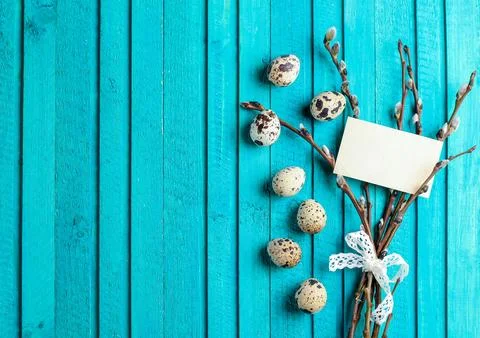 Happy easter concept. Quail eggs and willow branch on a wooden background. .. Stock Photos