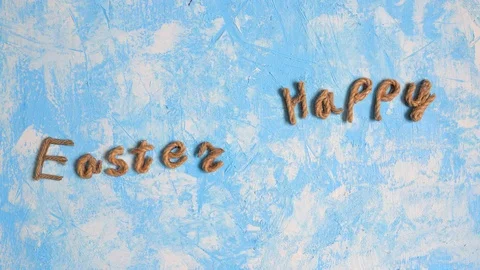 Happy Easter congratulation on the blue background, stop motion animation. Stock Footage 123904049