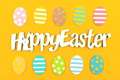 Happy Easter congratulatory background with easter eggs, text message, top vi Stock Photos