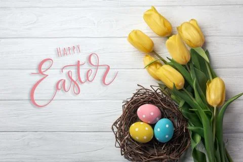 Happy Easter. Congratulatory easter background. Easter eggs and flowers. Stock Photos