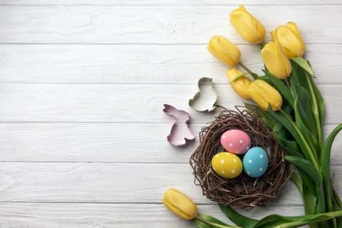Happy Easter. Congratulatory easter background. Easter eggs and flowers. Stock Photos