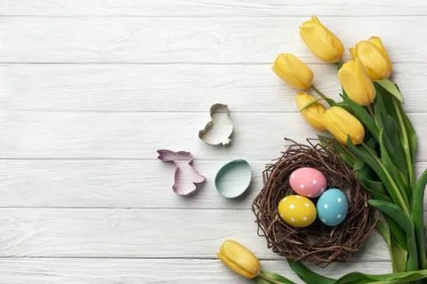 Happy Easter. Congratulatory easter background. Easter eggs and flowers. Stock Photos