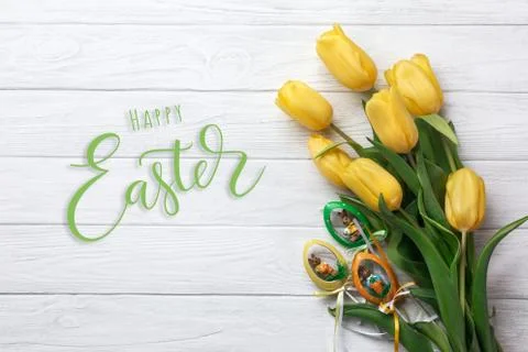 Happy Easter. Congratulatory easter background. Easter eggs and flowers. Stock Photos