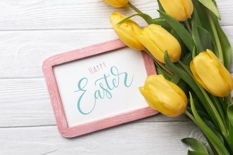 Happy Easter. Congratulatory easter background. Easter eggs and flowers. Stock Photos