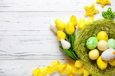 Happy Easter. Congratulatory easter background. Easter eggs and flowers. Back Stock Photos