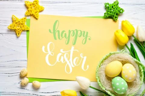 Happy Easter. Congratulatory easter background. Easter eggs and flowers. Sele Stock Photos