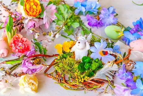 Happy Easter. Congratulatory easter background. Easter eggs, lamb and flowers. Stock Photos