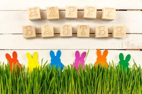 Happy Easter. Cubes with text on a white background. Fresh sprouts and Easter Stock Photos