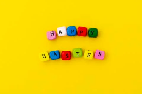 Happy Easter. Cubes with text on yellow background. Ready greating card desig Stock Photos