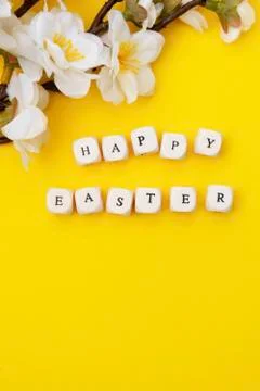 Happy Easter. Cubes with text on yellow background. Spring brunches with whit Stock Photos