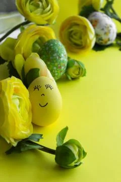 Happy Easter Day Around Yellow Flowers With Yellow Smiling Egg On a Yellow Ba Stock Photos