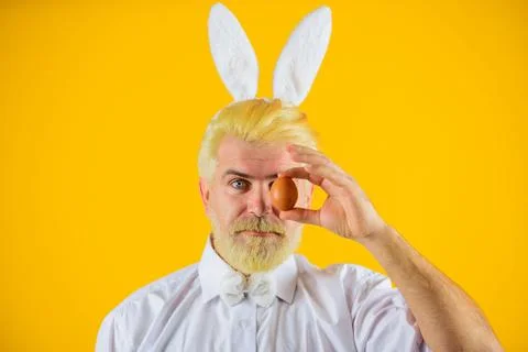 Happy Easter day. Bearded man in rabbit ears with Easter egg. Bunny rabbit .. Stock Photos