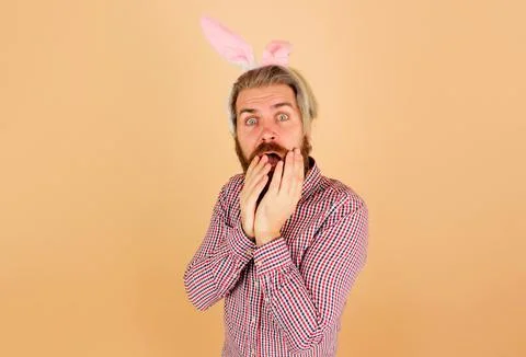 Happy Easter day. Bunny man in rabbit ears. Surprised bearded guy in bunny ea Stock Photos