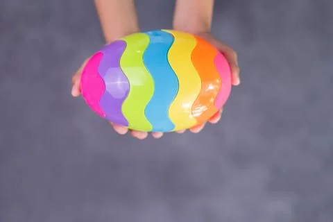 Happy Easter day. Kid hand with colorful egg toy. Happy and fun for celebrate Фото