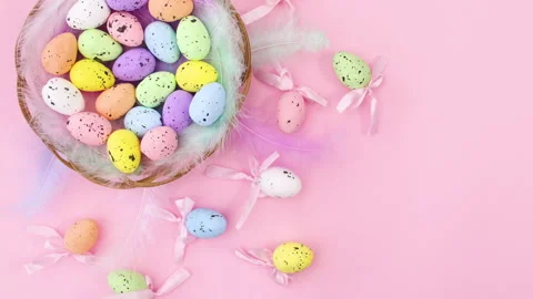 Happy Easter decoration with eggs in basket on pastel pink theme. Stop motion Stock Footage 147750594