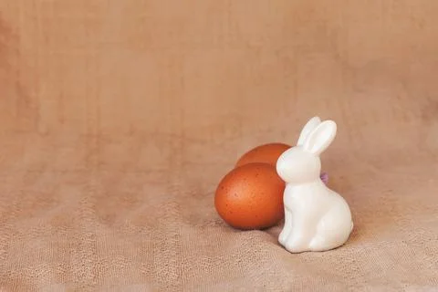 Happy easter decoration with white bunny decorative statuette and colorful eggs Photos