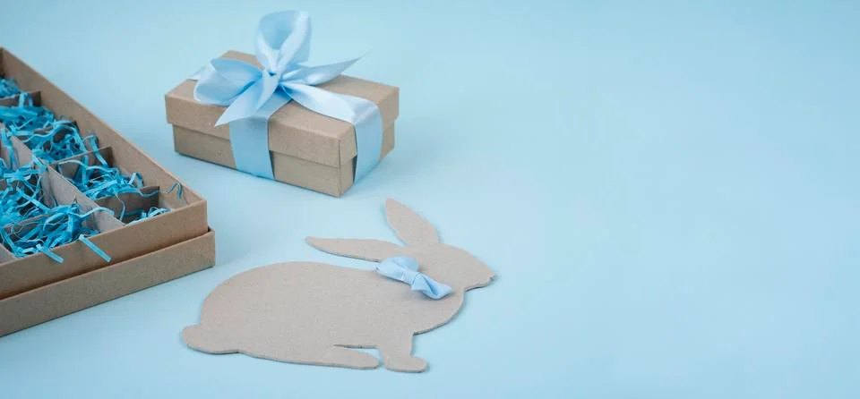 Happy Easter. Easter background in blue with a box of eggs, an Easter Bunny a Stock Photos