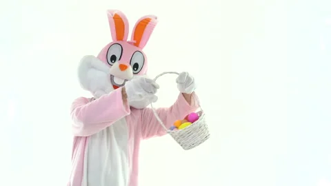 Happy Easter. Easter bunny rabbit hare holds basket throws colored eggs, shows Stock-Footage 149425520