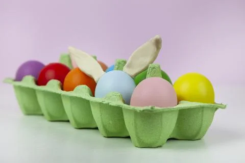 Happy Easter. Easter eggs. Chicken multicolored eggs on pink background. Stock Photos