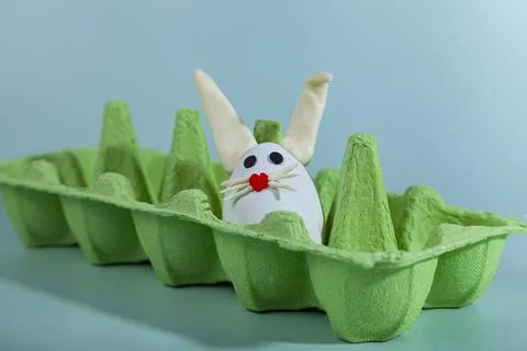 Happy Easter. Easter eggs. Chicken white eggs on green background. Stock Photos