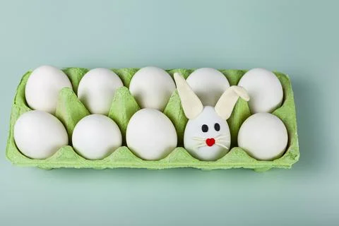 Happy Easter. Easter eggs. Chicken white eggs on green background. Stock Photos